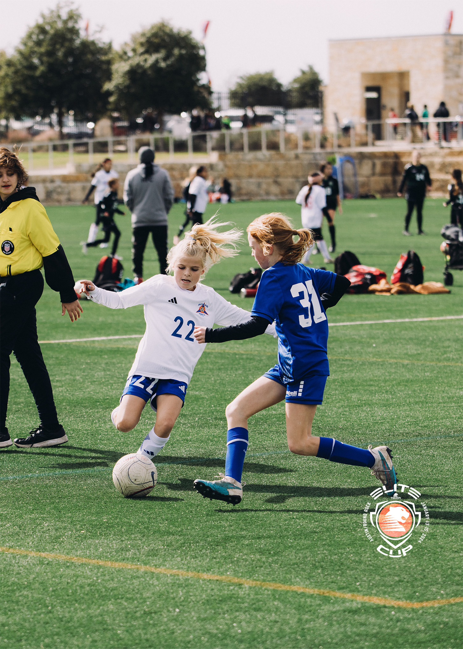 Two young players contesting the ball at a Tiger tournament