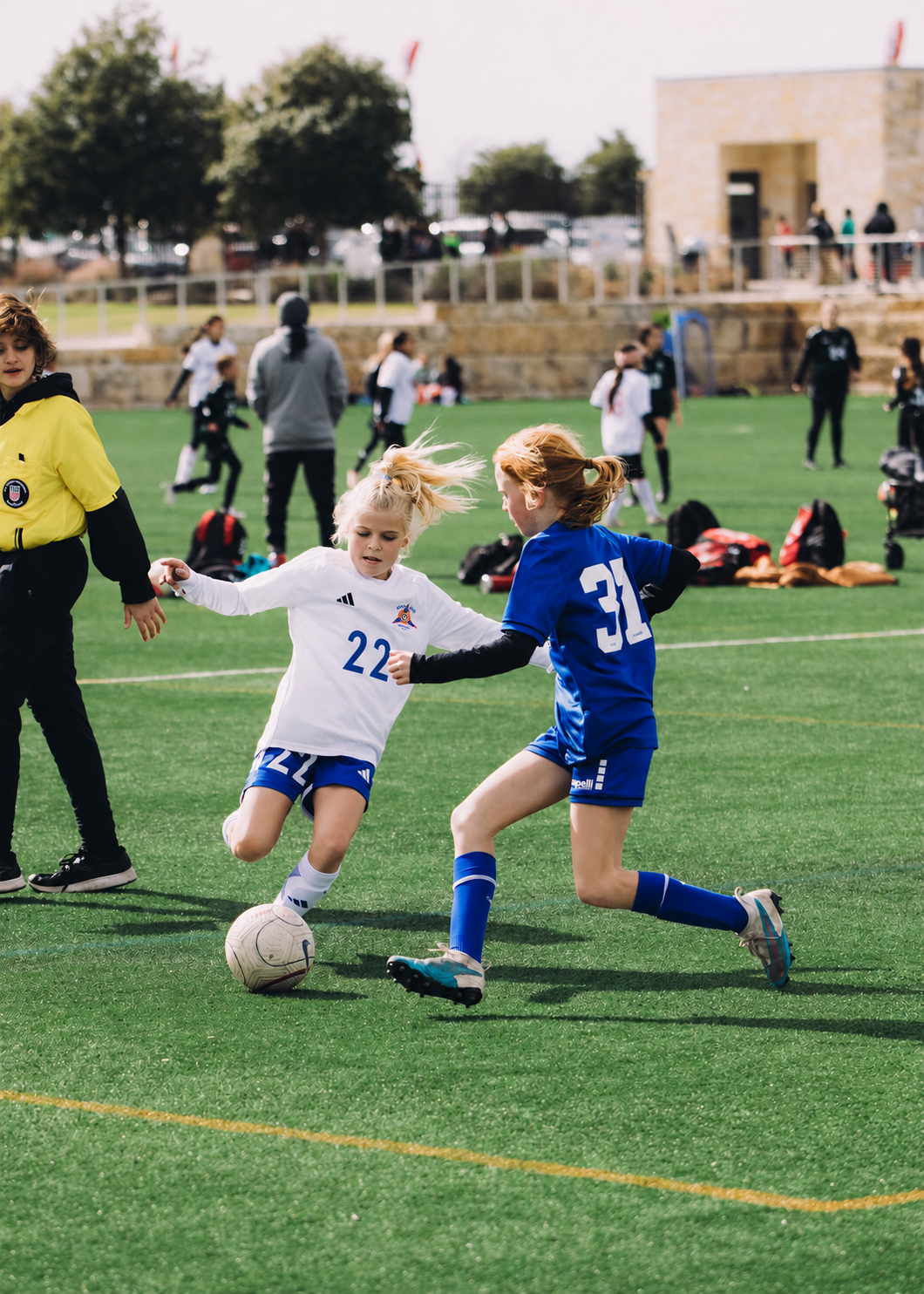 Two young players contesting the ball at a Tiger tournament